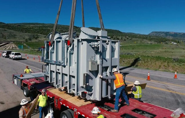 Crew from Winslow Crane Service moving a reactor on a trailer