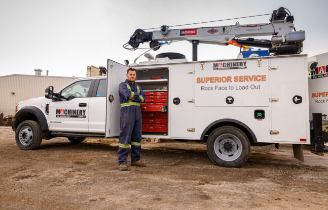 Machinery Supply service technician standing in front of his truck in Airdrie, Alberta, Canada