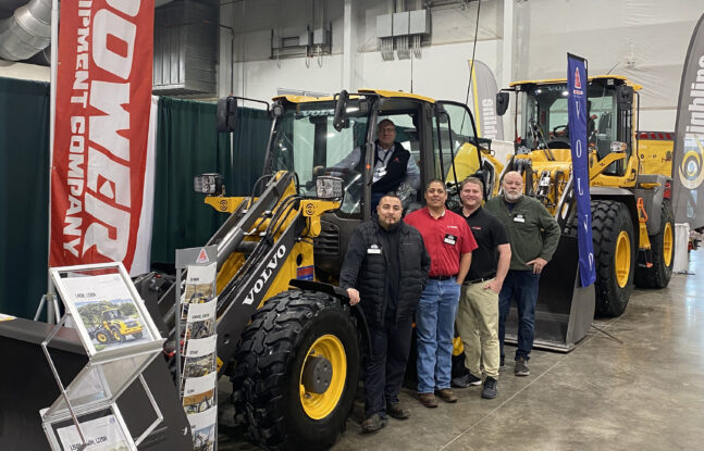 Five Power Equipment Company employees standing with Volvo wheel loader at 2023 Colorado Farm Show