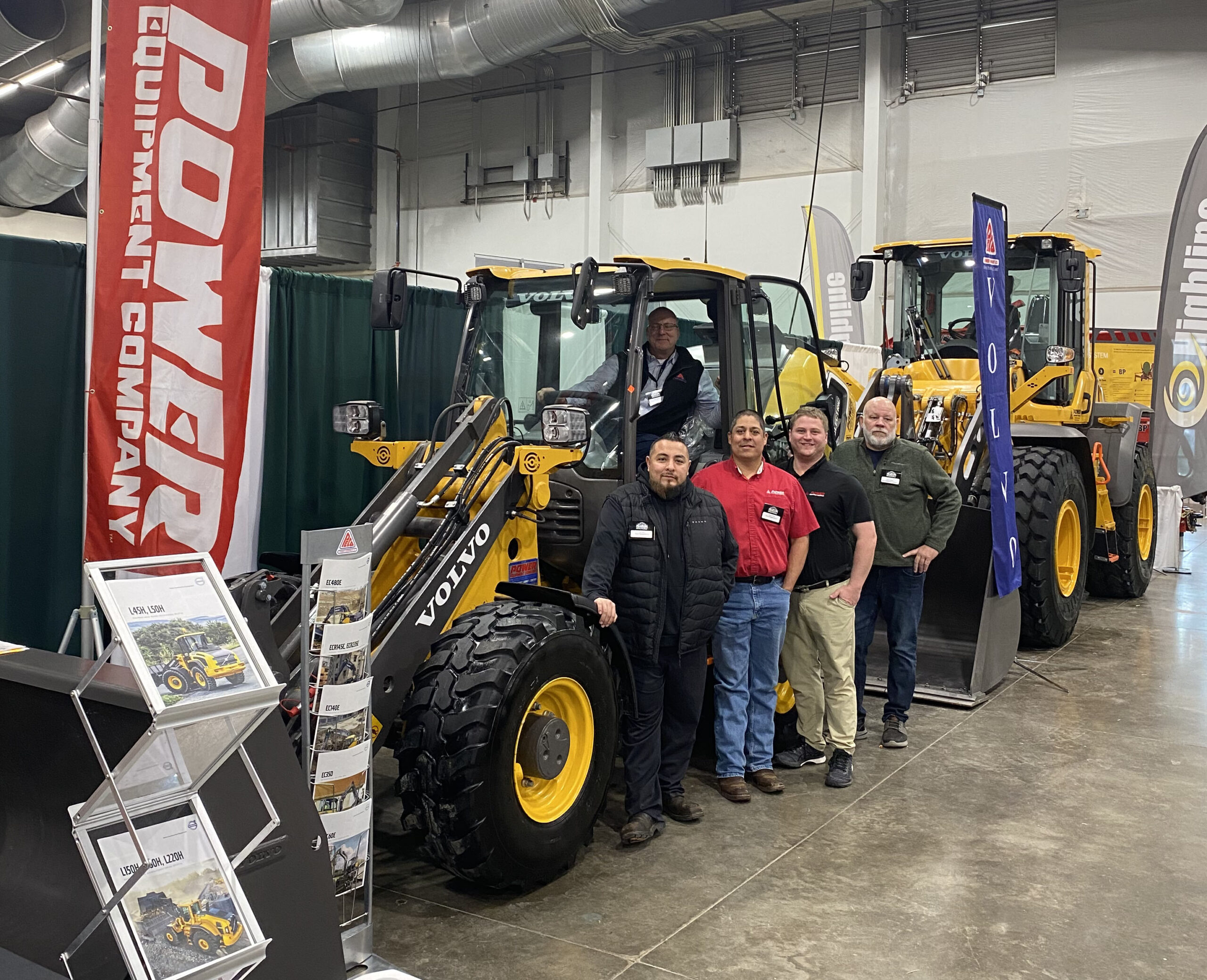 Five Power Equipment Company employees standing with Volvo wheel loader at 2023 Colorado Farm Show