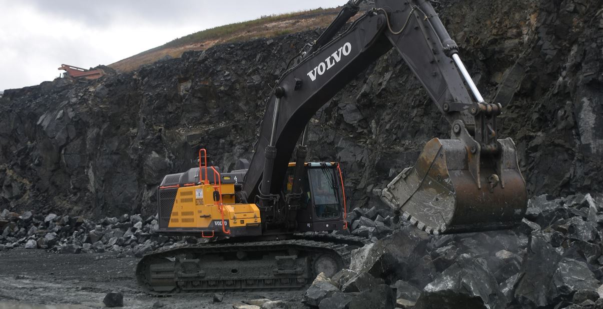 Volvo EC750 excavator moving large rocks at a Maryland quarry