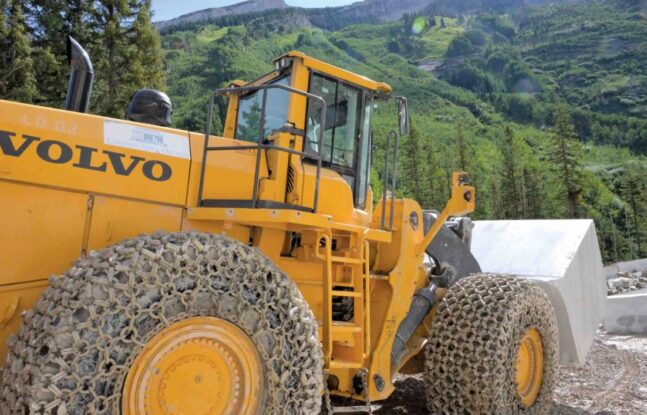 A large Volvo wheel loader is hauling marble stone at a quarry in Colorado