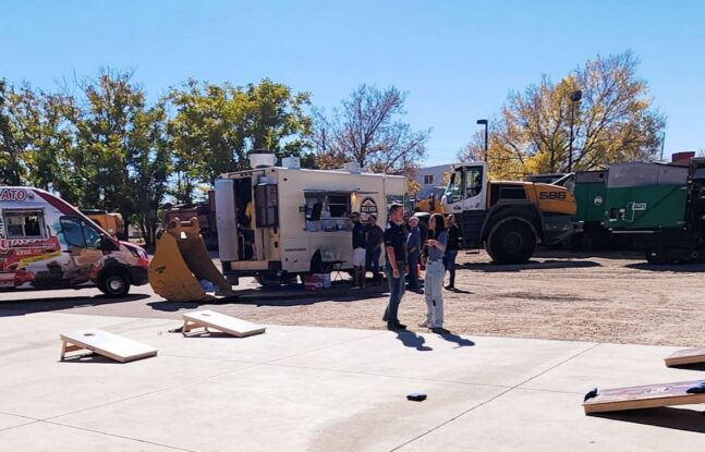 Employees and Family members playing cornhole and enjoying event at Power Screening in Henderson, Colorado.